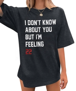 Detail of Taylor Swift lyric print on black oversized cotton t-shirt with drop shoulders