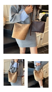 Detail view of suede bucket bag and small leather pouch with adjustable shoulder strap