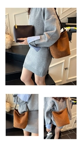 Detail view of caramel suede bucket bag and coffee leather clutch on a grey knit dress