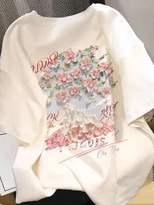 Detail of 3D embossed pink floral and mountain print on white cotton crewneck t-shirt