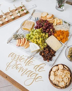 Flat lay of rectangular white marble cheese board with appetizers and French text