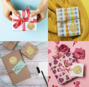 Detail showing gold foil Merry Christmas stickers used for elegant gift box packaging