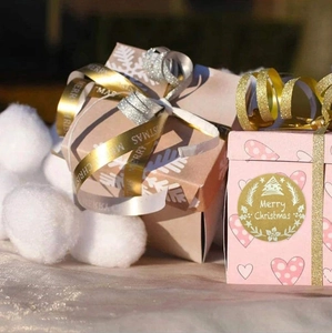 Kraft gift box with snowflake texture and golden Merry Christmas holiday sticker detail