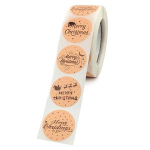 Roll of salmon-colored Merry Christmas stickers with gold Santa and reindeer graphics