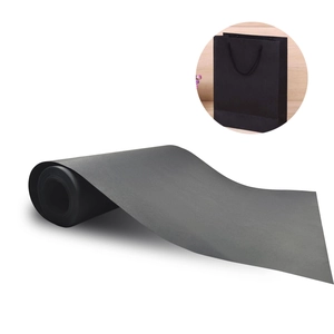 Premium black kraft paper roll for gift wrapping and DIY crafts shown with a black paper bag
