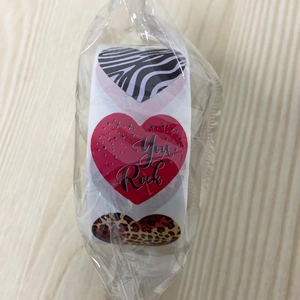 Detail of heart-shaped decorative stickers in a roll with zebra and leopard prints