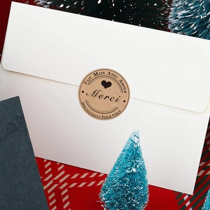 Kraft paper Merci stickers with heart on envelope for festive gift packaging
