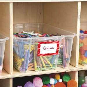 Clear plastic storage bin with colorful crayons and custom name label for kids organization