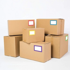 Macro detail of colorful dot border labels on various sized brown corrugated shipping boxes