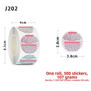 Macro detail of 1.5-inch round candle safety warning labels on a 500-sticker roll