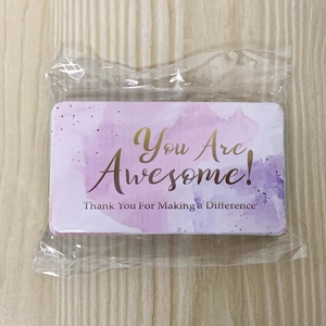 Detail of a reward card with purple watercolor design and You Are Awesome text in packaging