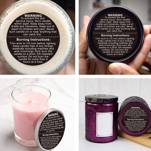 Detailed warning labels on assorted scented candle glass jars with clear safety instructions