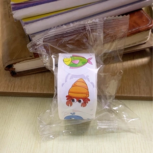 Macro shot of assorted colorful cartoon ocean animal reward stickers on a roll