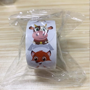Detailed view of rolled animal stickers featuring cute cow and fox designs for kids