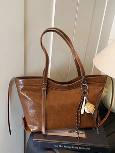 Vintage brown large capacity tote bag with glossy pleated texture and a baseball charm