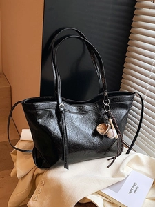 Retro black oil wax leather large tote bag with sports charms on casual blazer