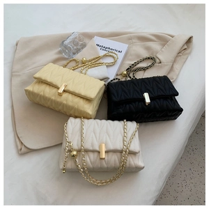 Quilted flap crossbody bags in yellow, black, and beige with gold chain and metal buckle