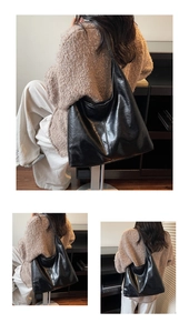 Detail of a large black faux leather tote with textured wrinkles and spacious interior