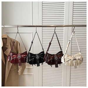 Detail of four Y2K style motorcycle underarm bags in burgundy, black, coffee, and beige colors