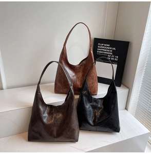 Detailed close-up showing glossy faux leather textures of hobo bags in three retro colors