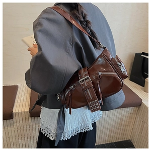 Side view of dark coffee glossy leather motorcycle bag showing biker style and metal zips
