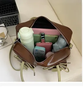 Macro view of brown faux leather shoulder bag interior showing large storage capacity