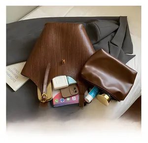 Interior view of brown woven tote bag showing large capacity for tablet and cosmetics