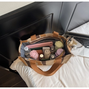Spacious interior of a striped canvas tote bag showing large capacity for daily essentials