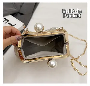Detail view of the internal slip pocket and grey herringbone lining inside the pearl shell bag