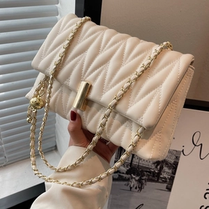 Chic beige quilted crossbody bag with gold chain strap and rectangular clasp detail