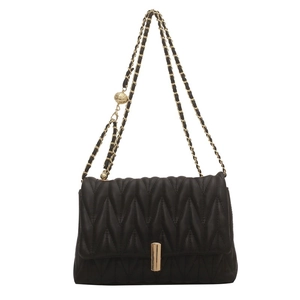 Classic black matelassé quilted chain bag with gold hardware and spherical metal charm