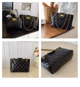 Detail view of black quilted leather tote bag with gold chain strap and turn-lock closure
