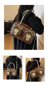 Close-up of brown vintage glossy bag with green bow details and flap outer pockets