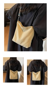 Detail of canvas tote with ethnic embroidered strap and side brand label view