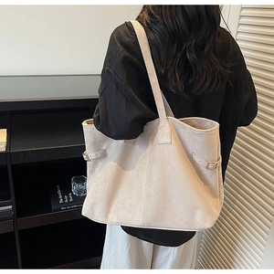 Detail of adjustable metal buckle on large suede tote bag with matte texture finish