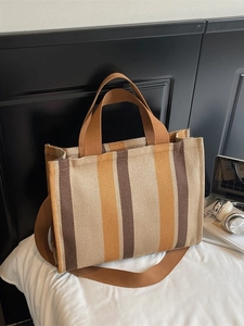 Vertical striped canvas tote bag in brown and mustard yellow with wide shoulder strap