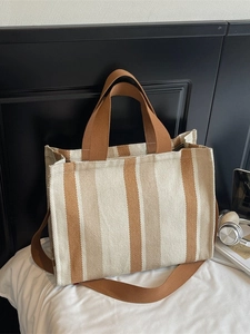 Vertical striped canvas tote bag with adjustable shoulder strap and large capacity