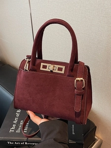 Vintage burgundy suede handbag with metal twist lock and shoulder strap for women