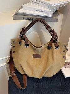 Retro khaki canvas tote bag with brown leather handles and adjustable shoulder strap