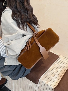 Retro brown suede shoulder bag for women with spacious minimalist design in a city style