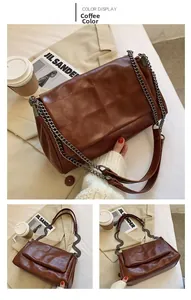 Detail view of coffee brown quilted shoulder bag with chic metal chain strap