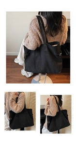 Detail view of black faux suede tote bag featuring adjustable metal side buckles and slim straps