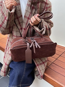 Deep brown frosted leather dumpling bag with metal zippers and crossbody strap for women