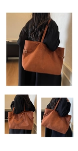 Detail of brown faux suede tote bag featuring adjustable side metal buckles and shoulder strap