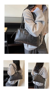 Detail view of retro gray-black shoulder bag with matte leather texture and side drawstring knot