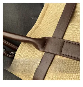 Close-up of minimalist tote bag with premium canvas texture and brown leather stitching