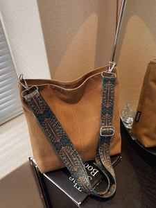 Brown canvas bucket bag with ethnic style printed wide shoulder strap for women