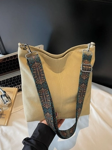 Large beige canvas bucket bag with wide ethnic pattern jacquard strap for women