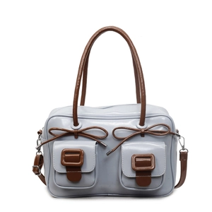 Light blue glossy crossbody bag with brown bow accents and double front flap pockets