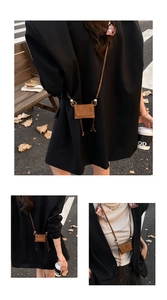Close-up of a brown suede mini crossbody bag with a slim strap and a retro buckle